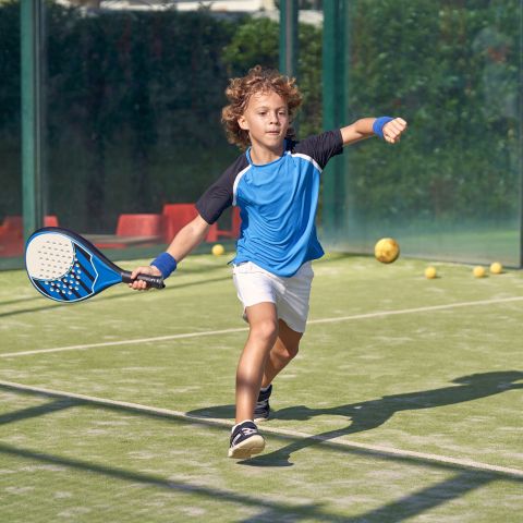Boy playing paddle tennis